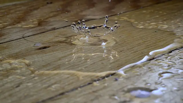 Water pooled on wood floor planks